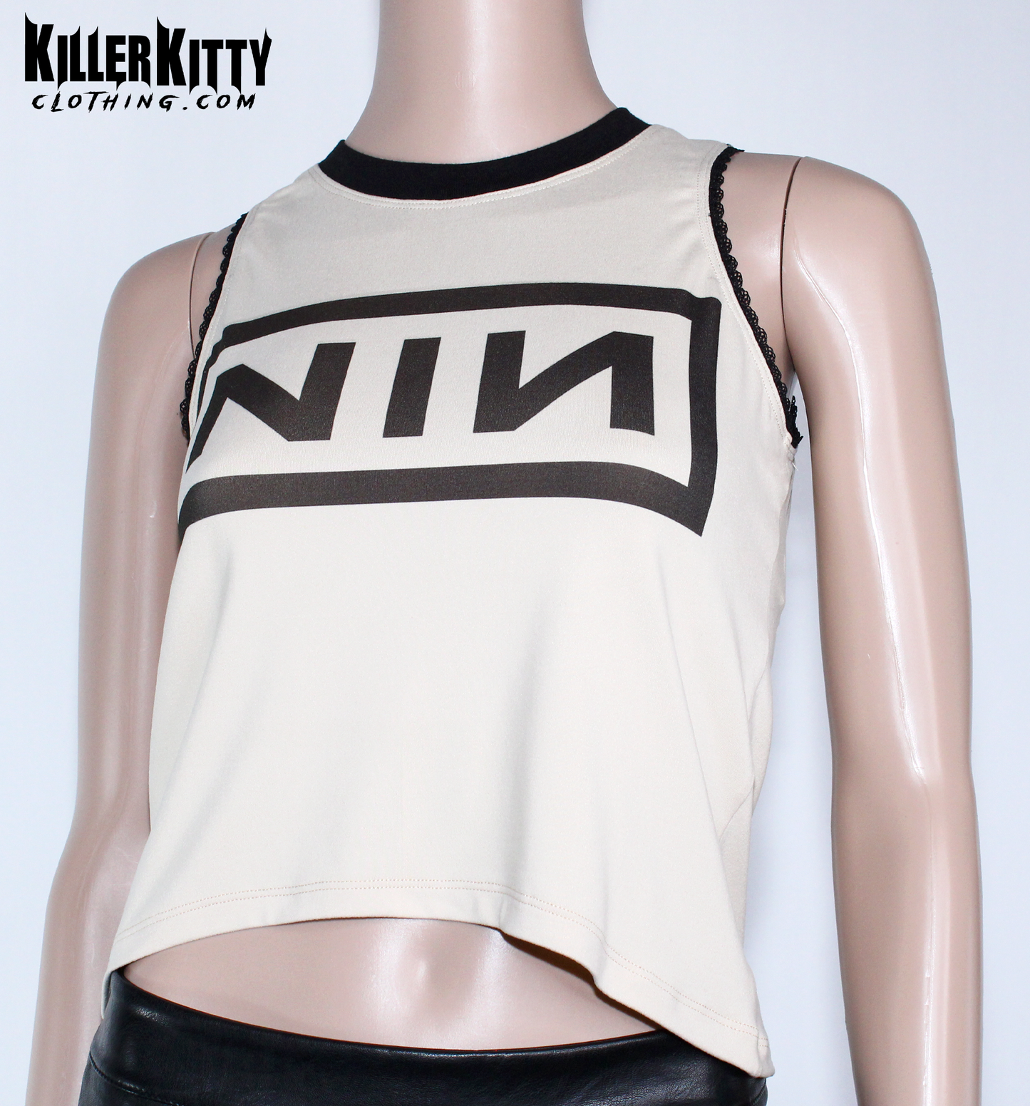 Nine Inch Nails Tank Top – Relaxed Fit Shirt Vintage tan with a black crew neck and black lace-edged trim at the arms. Customizable hem and length. Mannequin wearing a beige tank top with 'NIN' logo on a white background, branded 'Killer Kitty Clothing'.
