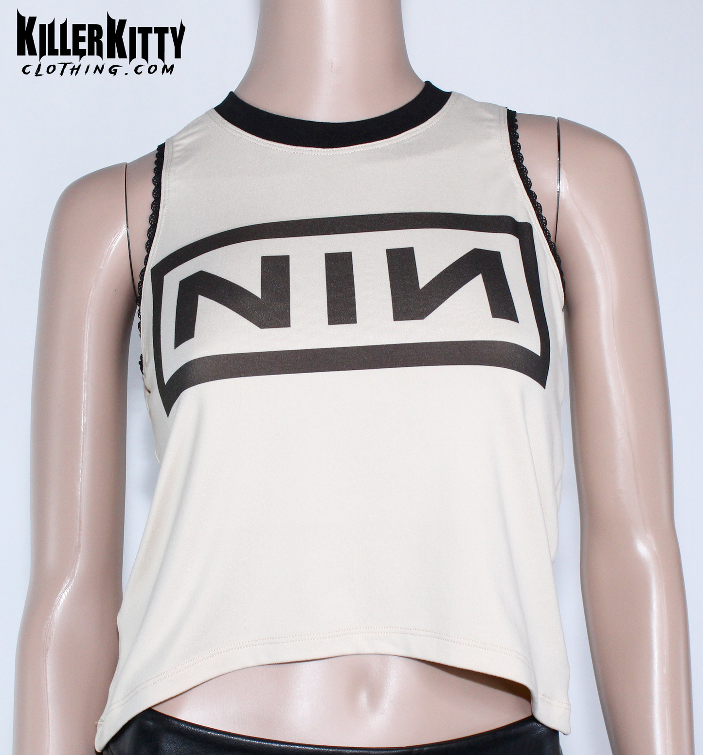 Nine Inch Nails Tank Top – Relaxed Fit Shirt Vintage tan with a black crew neck and black lace-edged trim at the arms. Customizable hem and length. Mannequin wearing a beige tank top with 'NIN' logo on a white background, branded 'Killer Kitty Clothing'.