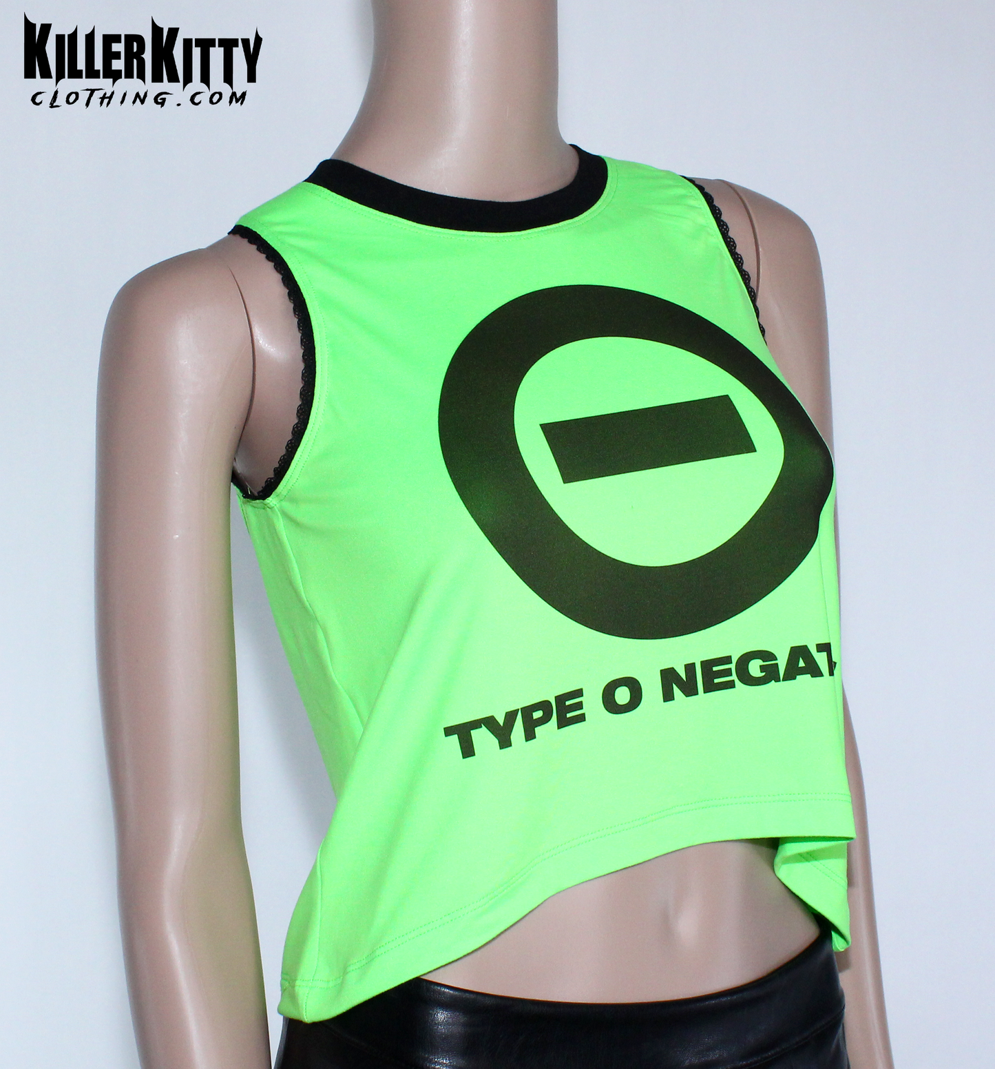 Women's Type O Negative tank top with a relaxed, slouchy fit. Peter Steele crop tank top. Top is neon green with the Type O Negative symbol logo on the front with "type o negative" underneath. Asymmetrical hem, black lace-edged arms and black crew neck. Band shirt. Killer Kitty Clothing Alternative Brand. Neon green tank top with Type O Negative logo on a mannequin, branded as Killer Kitty Clothing.