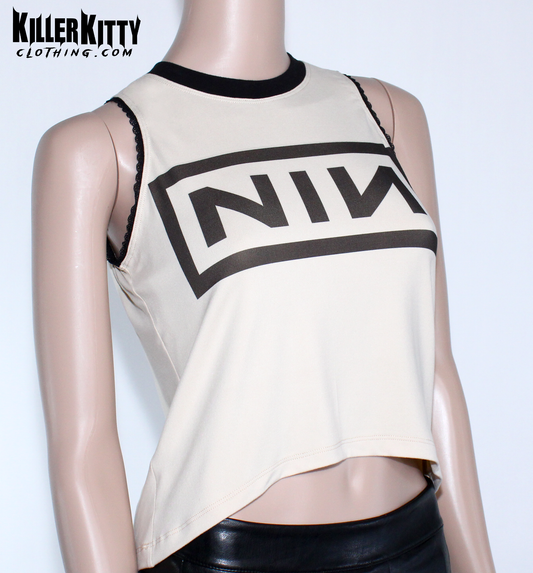 Nine Inch Nails Tank Top – Relaxed Fit Shirt Vintage tan with a black crew neck and black lace-edged trim at the arms. Customizable hem and length. Mannequin wearing a beige tank top with 'NIN' logo on a white background, branded 'Killer Kitty Clothing'.