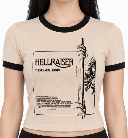 A tan ringer t-shirt with black trim on the crew neck and sleeves, featuring a black graphic print of the movie 'Hellraiser' on the front, modeled on a person against a white background. Women's Hellraiser ringer t shirt. 80s horror cult classic hellraiser. women's pinhead shirt. spooky horror shirts for women. 80s horror shirts for women. women's ladies vintage pinhead hellraiser shirt. alternative 90s clothes for women. killer kitty clothing horror tees for women. angel to some demon to others shirt. 