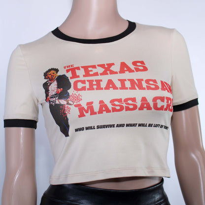 Texas Chainsaw Massacre t-shirt. Vintage looking tan shirt with a graphic of Leatherface holding his trusty chainsaw. Next to him is the title in red, "The Texas Chainsaw Massacre" In smaller black letters underneath, "Who will Survive and What will be Left of Them". This horror movie ringer tee has a black crew neck and black trim on its short sleeves. Customizable length. Made from ultra soft Double Brushed Cotton, Poly, Spandex fabric. Made by alt brand Killer Kitty Clothing