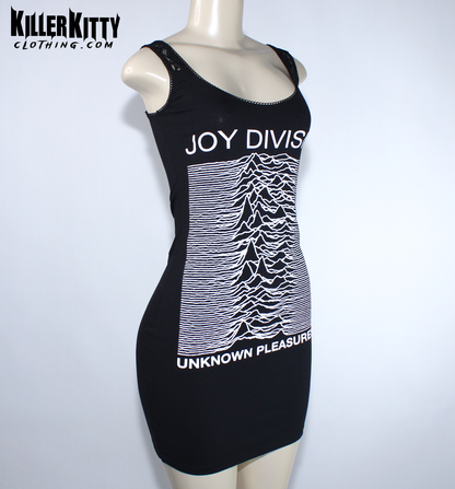 A black sleeveless bodycon dress displayed on a mannequin. The dress features the white 'Joy Division' band name and their 'Unknown Pleasures' album cover graphic printed on the front. Joy Division unknown pleasures shirt. joy division unknown pleasure dress. alternative band merch for women. Joy Division lace dress. post punk dresses for women. Ian Curtis dress for women. handmade alternative fashion killer kitty clothing. diy upcycled unique band dresses. joy division bodycon dress.