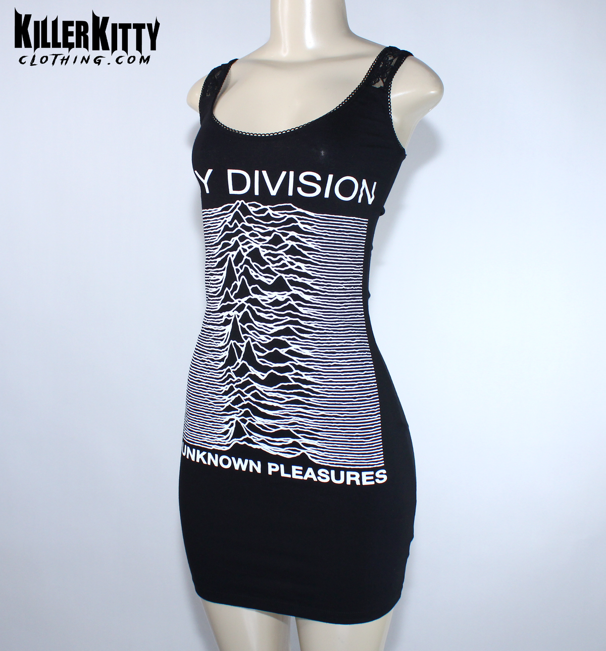 A black sleeveless bodycon dress displayed on a mannequin. The dress features the white 'Joy Division' band name and their 'Unknown Pleasures' album cover graphic printed on the front. Joy Division unknown pleasures shirt. joy division unknown pleasure dress. alternative band merch for women. Joy Division lace dress. post punk dresses for women. Ian Curtis dress for women. handmade alternative fashion killer kitty clothing. diy upcycled unique band dresses. joy division bodycon dress.