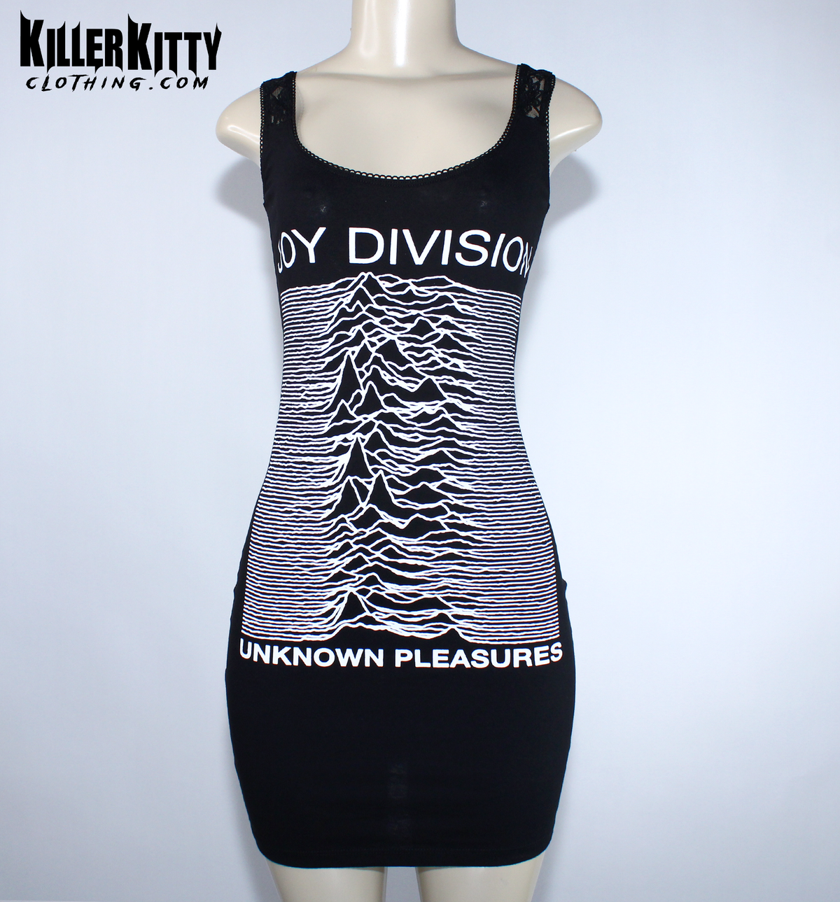 A black sleeveless bodycon dress displayed on a mannequin. The dress features the white 'Joy Division' band name and their 'Unknown Pleasures' album cover graphic printed on the front. Joy Division unknown pleasures shirt. joy division unknown pleasure dress. alternative band merch for women. Joy Division lace dress. post punk dresses for women. Ian Curtis dress for women. handmade alternative fashion killer kitty clothing. diy upcycled unique band dresses. joy division bodycon dress.