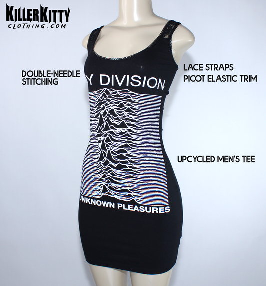 A black sleeveless bodycon dress displayed on a mannequin. The dress features the white 'Joy Division' band name and their 'Unknown Pleasures' album cover graphic printed on the front. Joy Division unknown pleasures shirt. joy division unknown pleasure dress. alternative band merch for women. Joy Division lace dress. post punk dresses for women. Ian Curtis dress for women. handmade alternative fashion killer kitty clothing. diy upcycled unique band dresses. joy division bodycon dress.